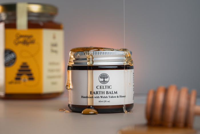 Jar of Celtic Earth Tallow Balm on a table with a blurred background